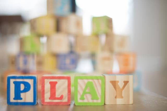 Play spelled out in letter blocks