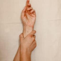 Photo of just arms and the hand is holding the wrist